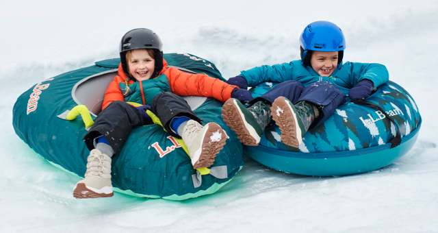 Kids sledding in snow tubes