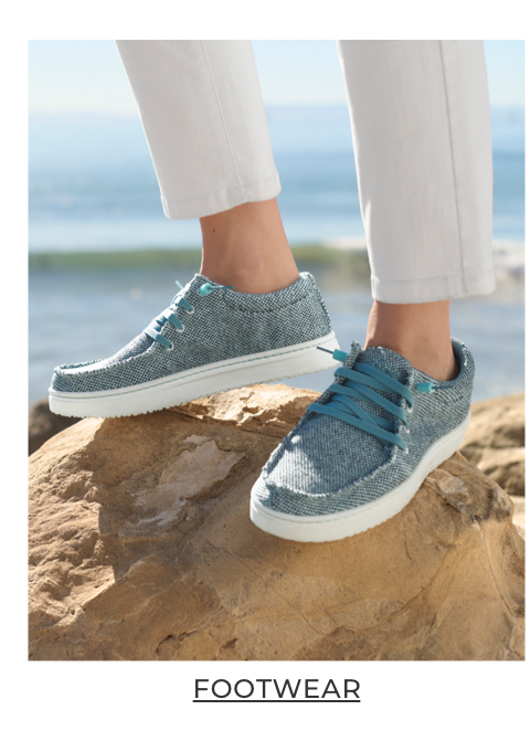 Women standing on a rock.