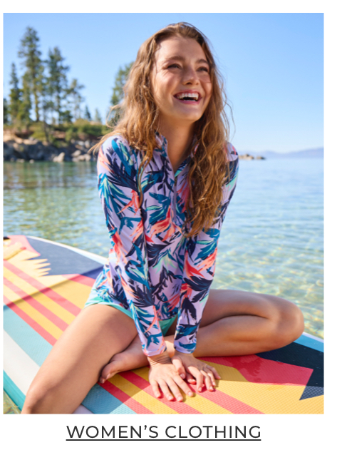 Women sitting on a paddleboard.